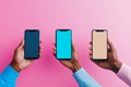 Three hands holding smartphones with blank screen on a pink background Royalty Free Stock Photo