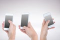 Three hands holding smartphones Royalty Free Stock Photo