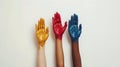 Three colorful painted hands raised against white background. symbol of diversity and creativity. ideal for educational Royalty Free Stock Photo