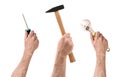 Three hands with screwdriver, hammer, and wrench on white background