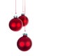 Three hanging Christmas balls at a white background