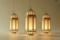 Three Hanging Islamic Lanterns with Soft Yellow Light on a Neutral Studio Background Royalty Free Stock Photo