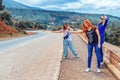 Three happy, beautiful girls vote on the road