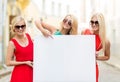 Three happy blonde women with blank white board Royalty Free Stock Photo