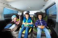 Three happy boys sitting in safety car seats Royalty Free Stock Photo