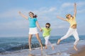 Three happy children running on the beach at the day time. Royalty Free Stock Photo