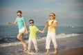 Three happy children running on the beach at the day time. Royalty Free Stock Photo