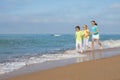 Three happy children running on the beach at the day time. Royalty Free Stock Photo