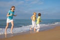 Three happy children running on the beach at the day time. Royalty Free Stock Photo