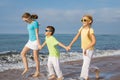 Three happy children running on the beach at the day time. Royalty Free Stock Photo