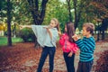 Three happy children talking and eating pizza outdoors Royalty Free Stock Photo