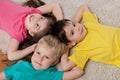 Three happy children on the white carpet