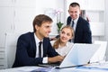 Three happy coworkers working in company office Royalty Free Stock Photo