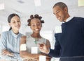 Three happy diverse businesspeople writing ideas and brainstorming together in an office at work. Cheerful hispanic Royalty Free Stock Photo