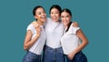 Three Happy Diverse Girls Hugging On Turquoise Studio Background, Panorama