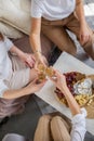 Three happy female friends drinking champagne cheers together laughing having positive emotion Royalty Free Stock Photo