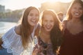 Three happy female friends standing together on beach Royalty Free Stock Photo