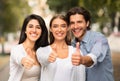 Three Happy Friends Gesturing Thumbs Up Standing Outdoor Royalty Free Stock Photo