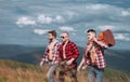 Three happy friends are looking on mountains and having fun together. Group of friends on country walk on a summer day Royalty Free Stock Photo