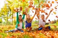 Three happy friends playing with thrown leaves Royalty Free Stock Photo