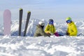 Three happy friends snowboarders and skier are having lunchtime on ski slope in sunny day in the mountains Royalty Free Stock Photo