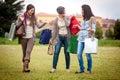 Three happy girls doing shopping