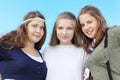 Three happy girls hug at background of sky Royalty Free Stock Photo