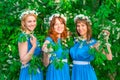 Three Happy Girls In Identical Dresses Posing In The Garden