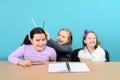 Three happy girls making jokes in school