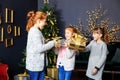Three happy kids give gifts boxes. Concept of holidays, merry christmas and family Royalty Free Stock Photo