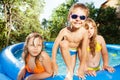 Three happy kids having fun in swimming pool Royalty Free Stock Photo