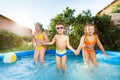 Three happy kids jumping in the swimming pool Royalty Free Stock Photo