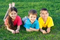 Three happy kids lying on the field Royalty Free Stock Photo