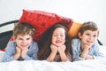 Three happy kids in pajamas celebrating pajama party. Preschool and school boys and girl having fun together Royalty Free Stock Photo