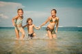 Three happy kids playing on beach Royalty Free Stock Photo