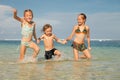 Three happy kids playing on beach Royalty Free Stock Photo