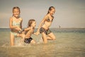 Three happy kids playing on beach Royalty Free Stock Photo