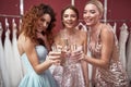 Three happy ladies clanging of champagne glasses Royalty Free Stock Photo