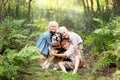 Three Happy Children Lovinglt Hugging the Pet Dog in the Forest Royalty Free Stock Photo