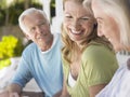 Three Happy Mature People Sitting On Verandah Royalty Free Stock Photo