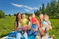 Three happy mothers holding cute babies in park