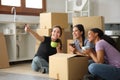 Three happy roommates planning decoration moving house Royalty Free Stock Photo