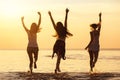 Three happy girls at caml sea beach and sunset Royalty Free Stock Photo