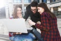 Three happy smiling high school teenager students with laptop a Royalty Free Stock Photo