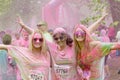 Three happy smiling woman covered with pink color powder