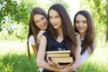 Three happy student girl with books in the park Royalty Free Stock Photo