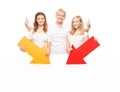 Three happy teenagers holding colorful arrows Royalty Free Stock Photo