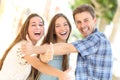 Three happy teenagers laughing with thumbs up