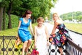 Three happy women in a summer park Royalty Free Stock Photo