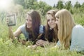 Three happy young girlfriend doing selfie by phone